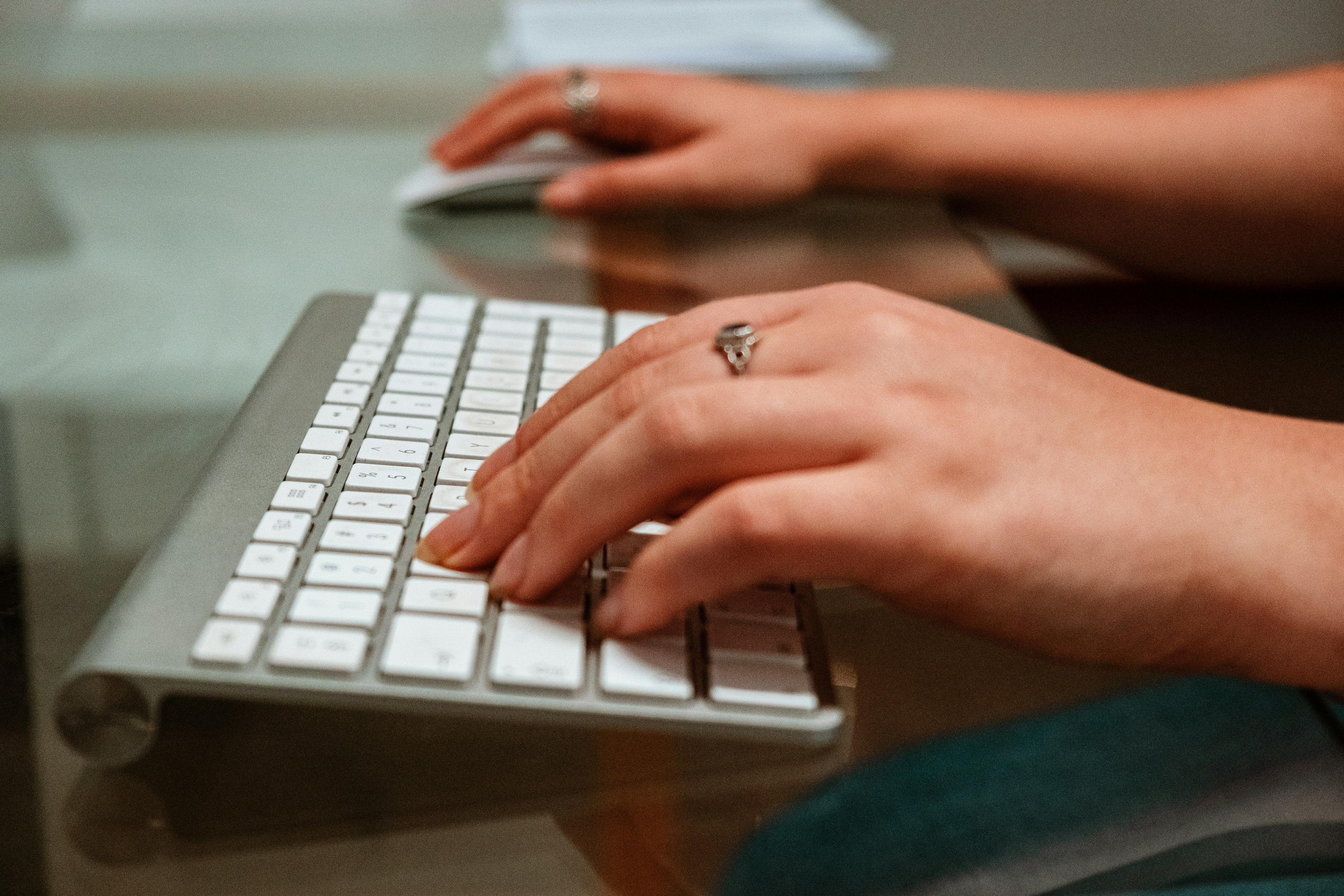 a womans hand on a computer keyboard