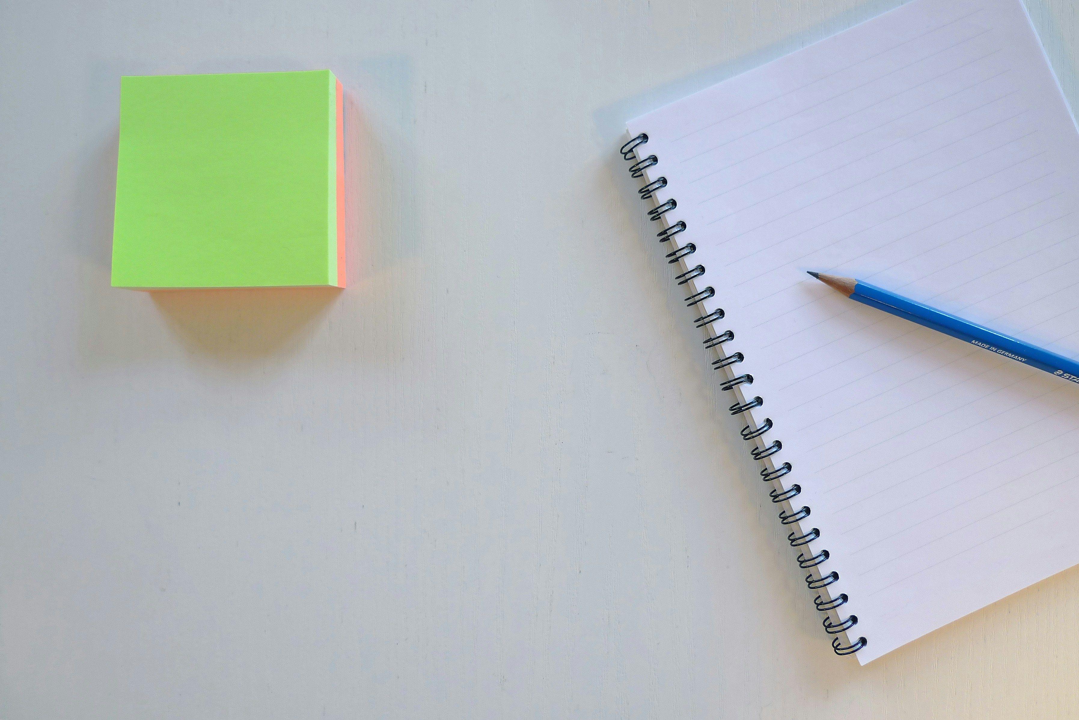 a notepad and a pencil on a table