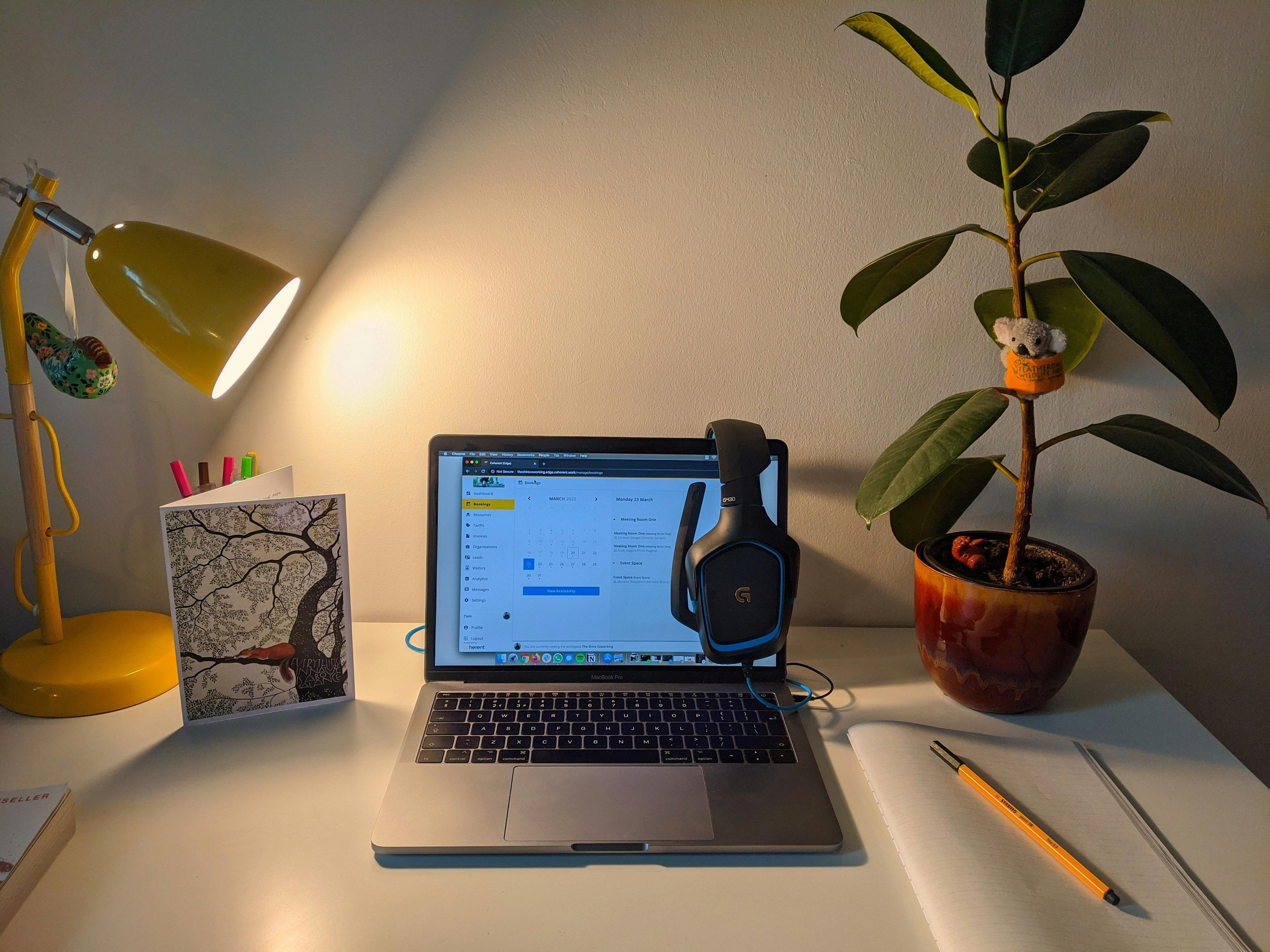 a laptop computer sitting on top of a white desk