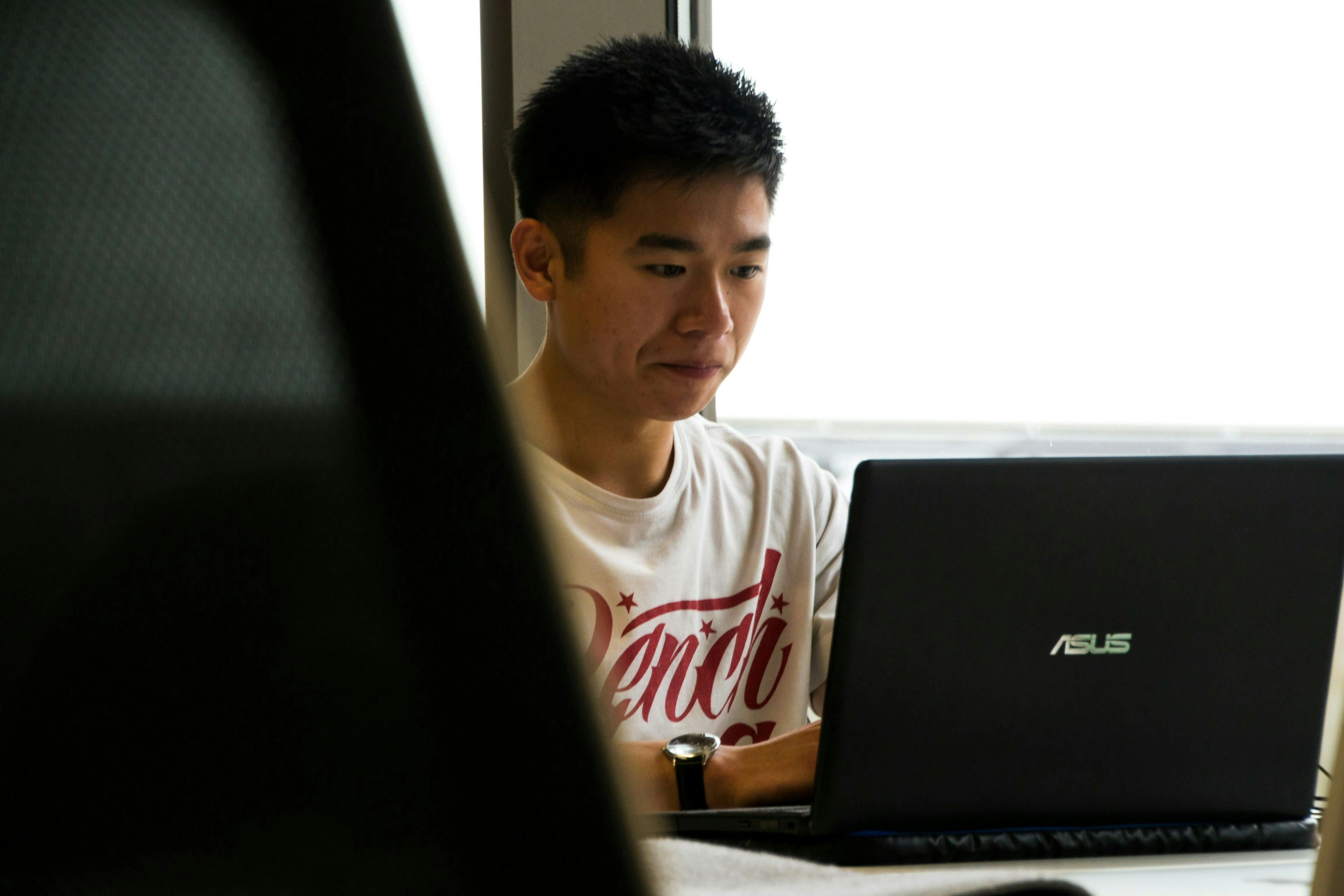 un homme assis devant un ordinateur portable
