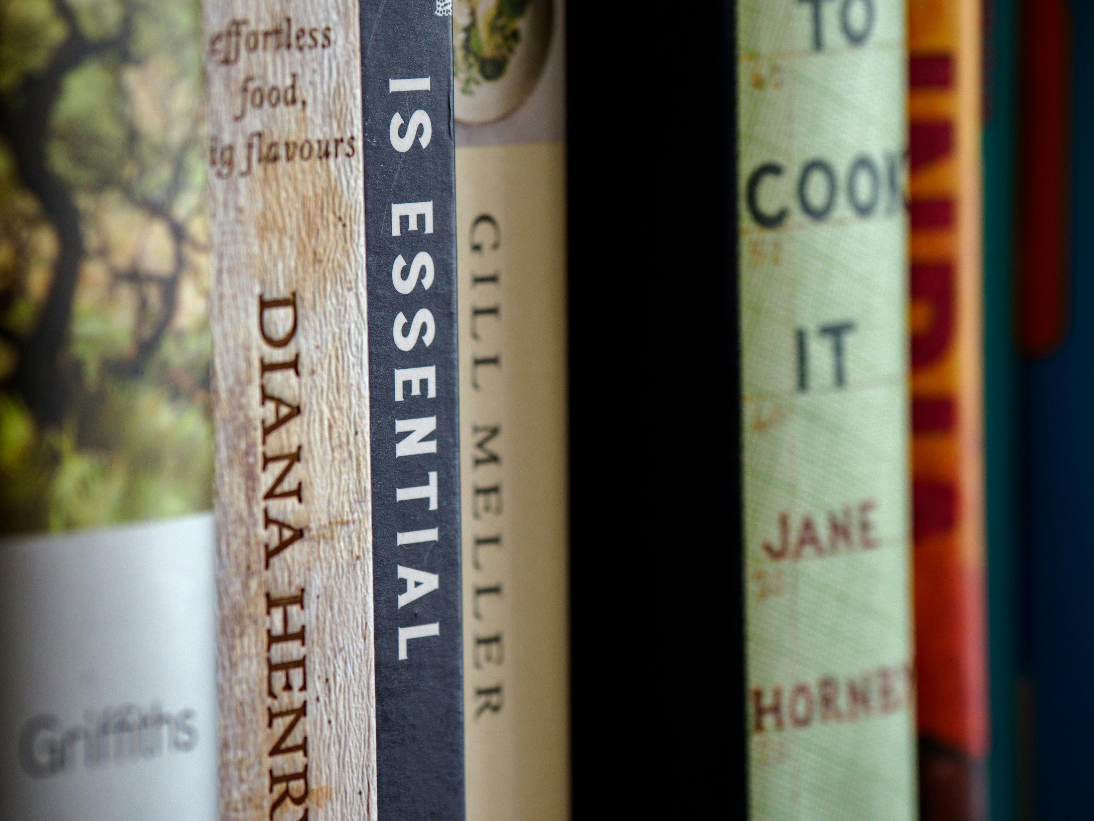 a row of books sitting on top of a shelf