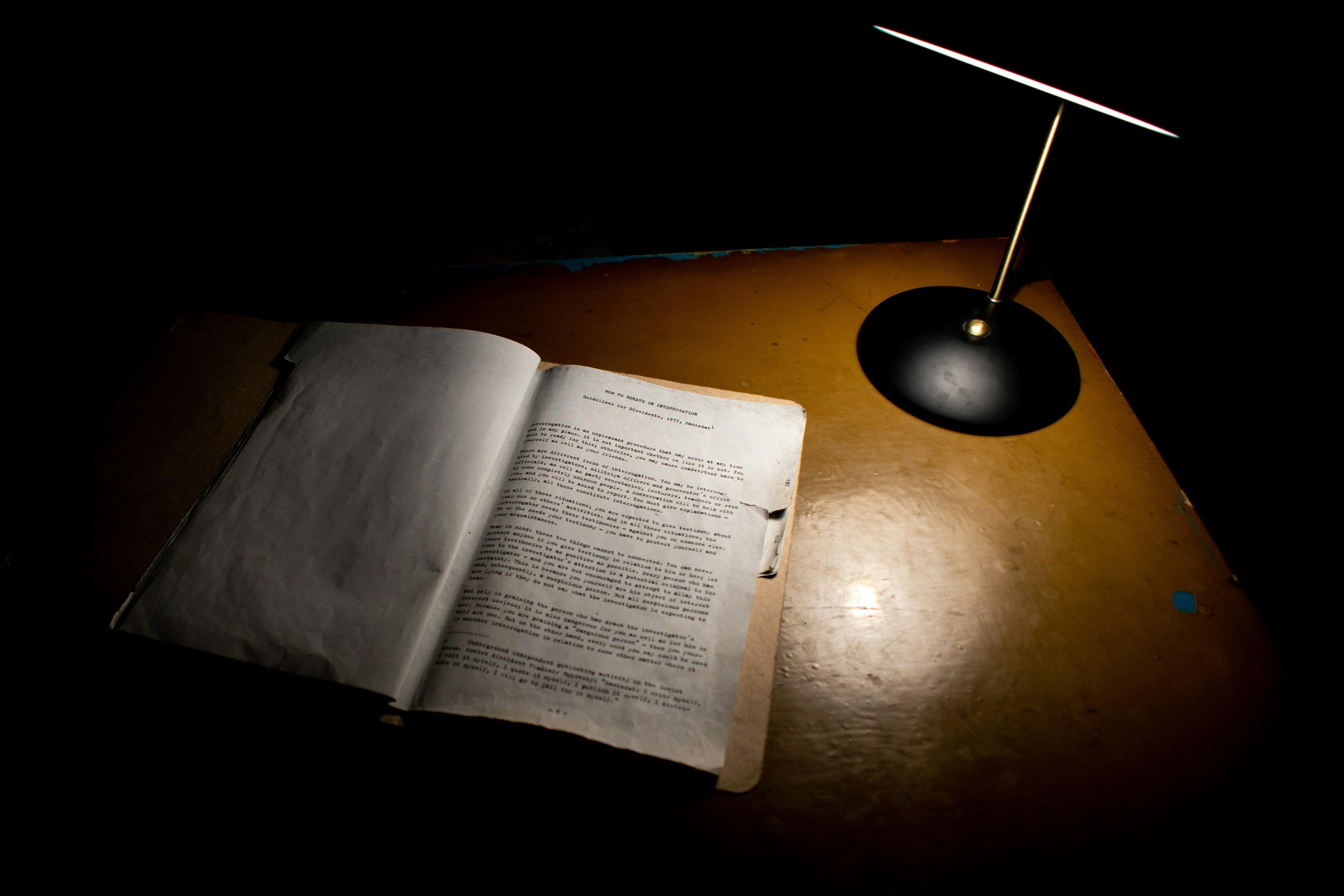 an open book sitting on top of a wooden table