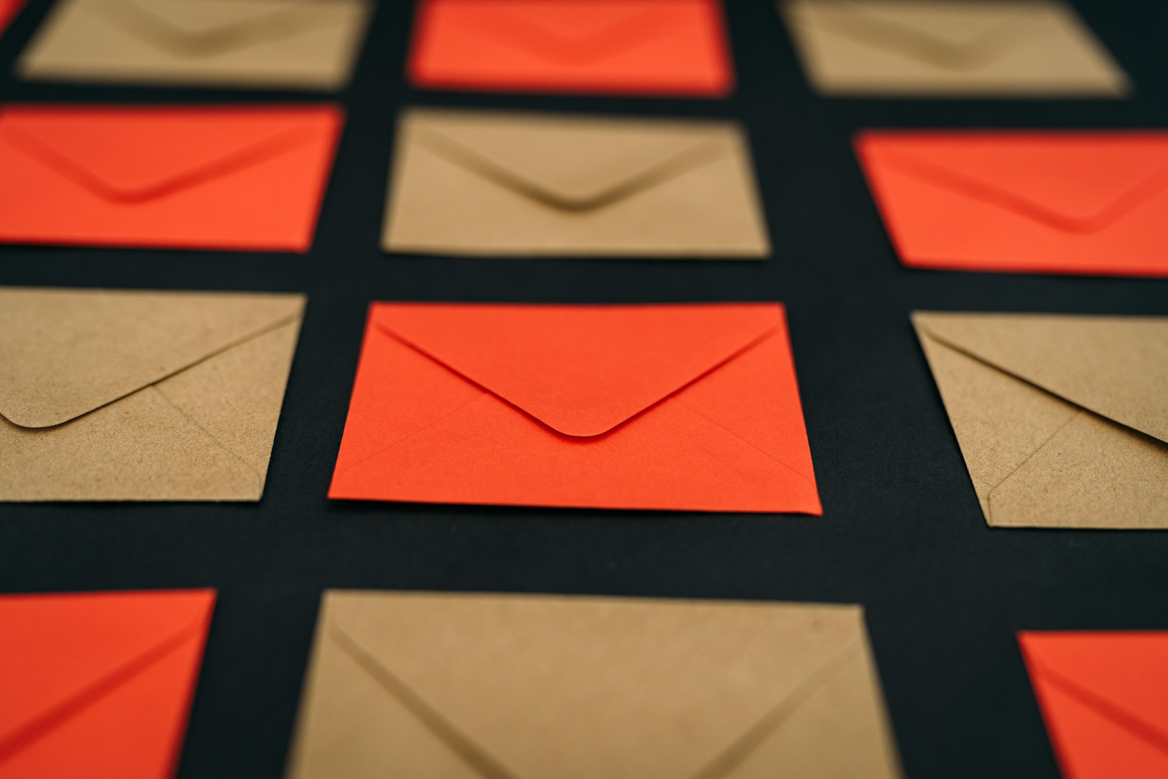 a group of orange and brown envelopes on a black surface